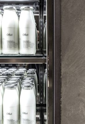 a refrigerator filled with lots of bottles of milk