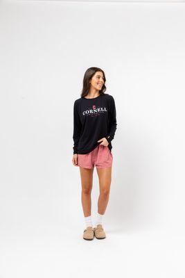 a woman wearing a black sweatshirt and pink shorts