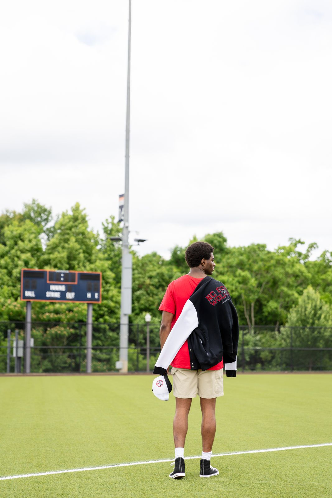 a man standing on a field holding a frisbee