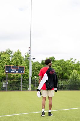 a man standing on a field holding a frisbee