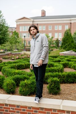 a man standing on top of a brick wall