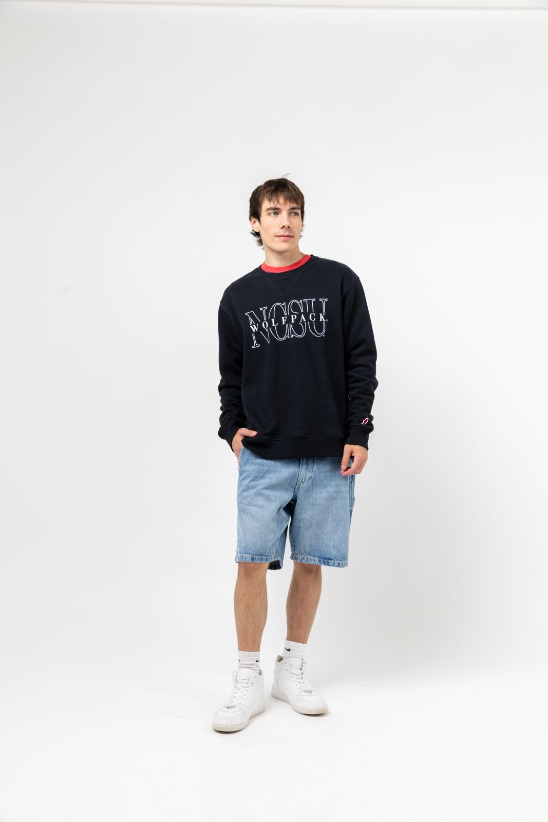 a man standing in front of a white background