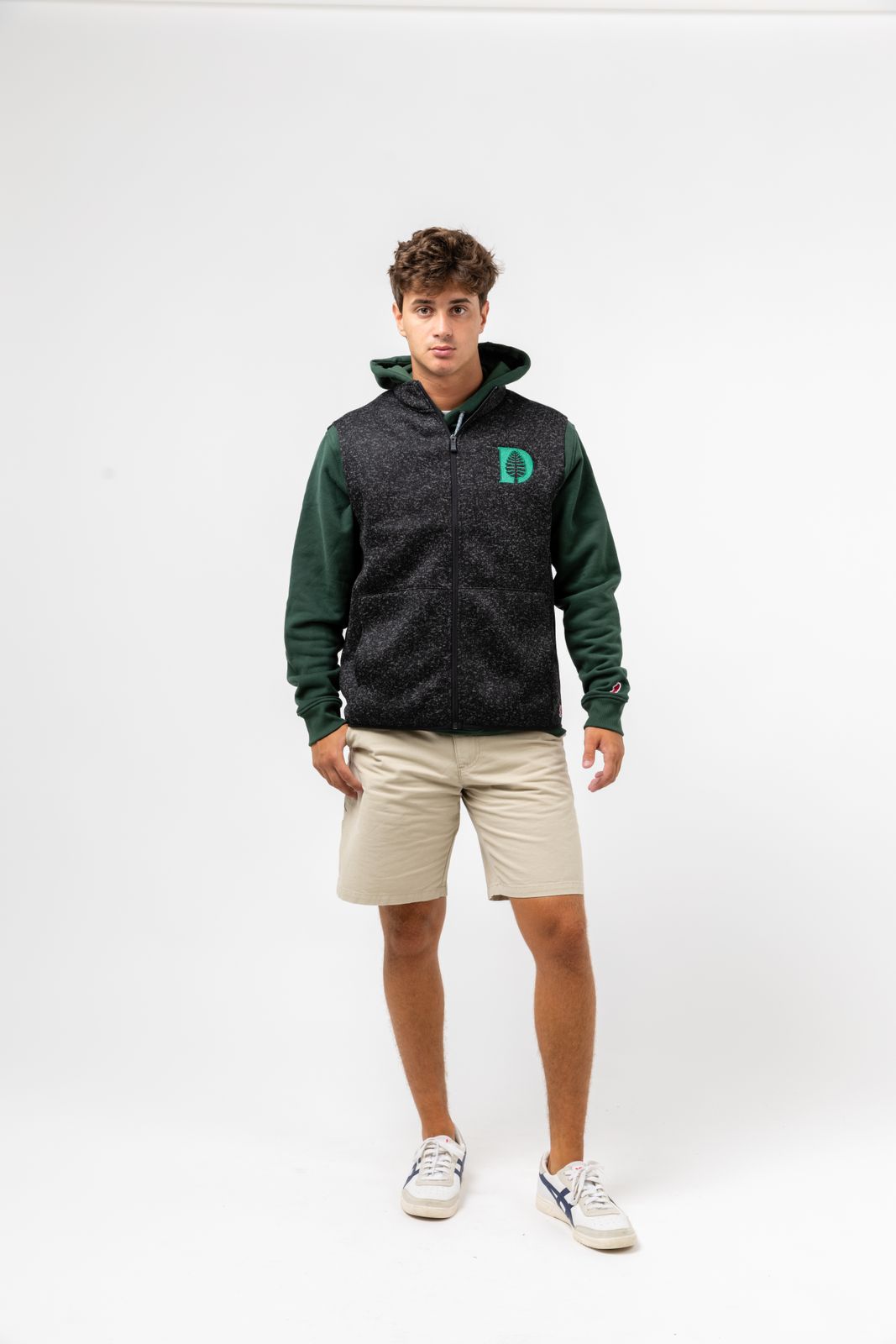 a young man standing in front of a white background