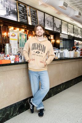 a man standing in front of a counter in a restaurant
