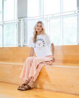a woman sitting on the steps of a building