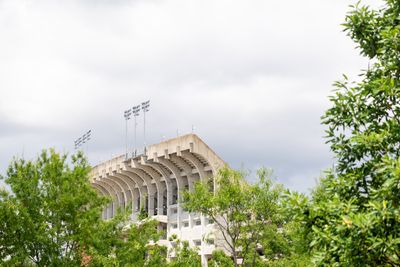 a tall building with a lot of flags on top of it