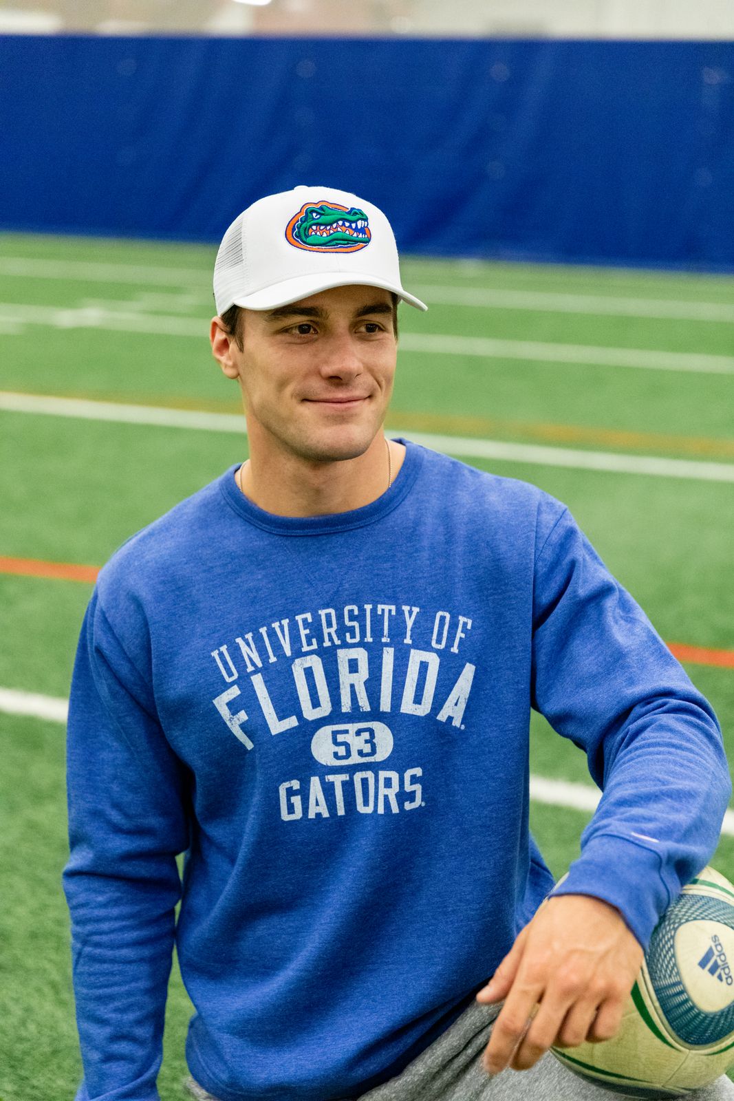 a man holding a ball on a football field