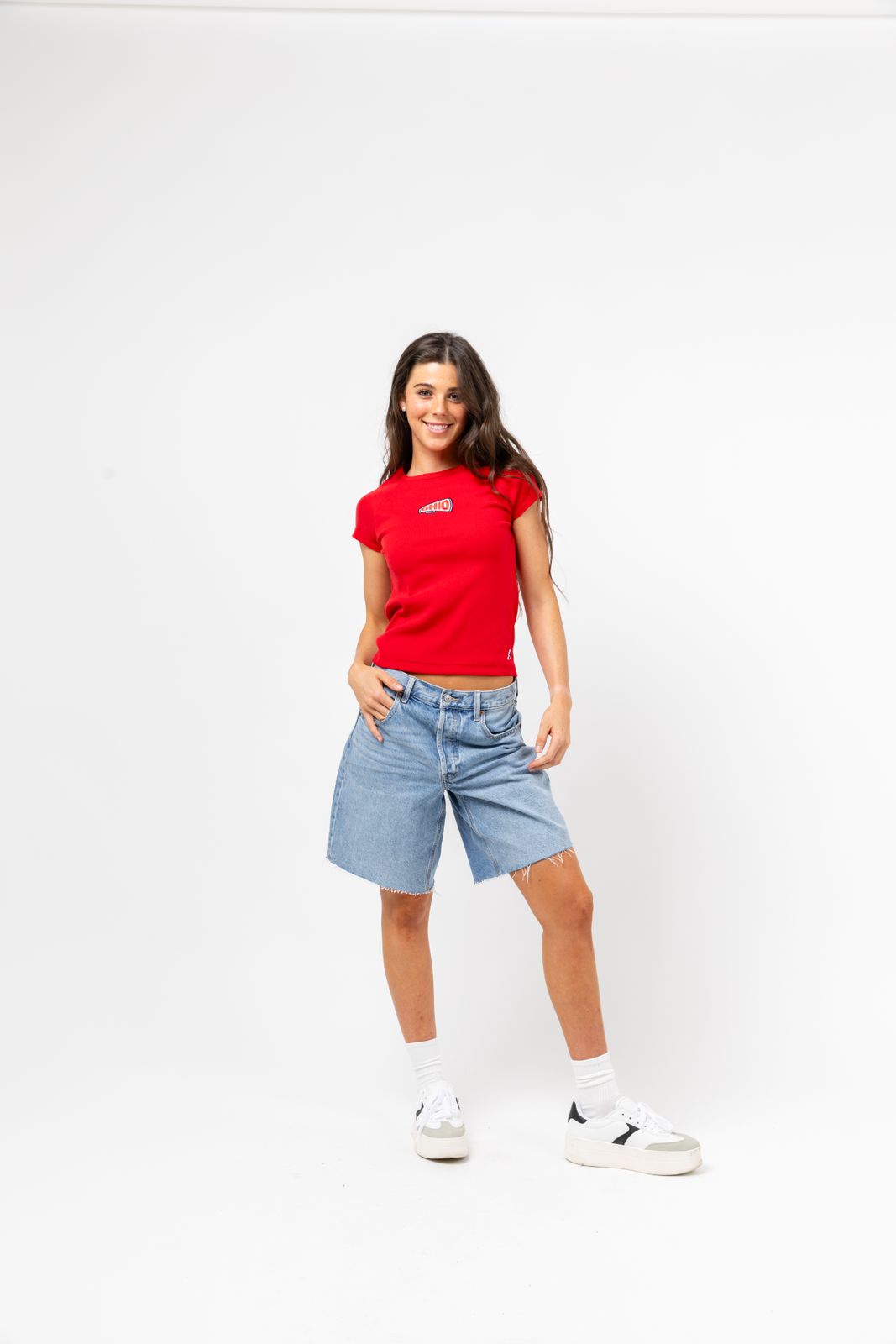 a woman in a red shirt is posing for a picture