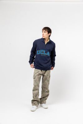 a young man standing in a white room