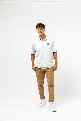 a man standing in a white shirt and khaki pants