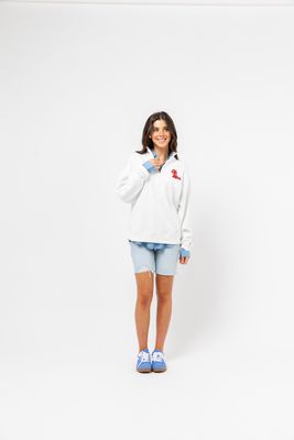 a woman standing in front of a white background