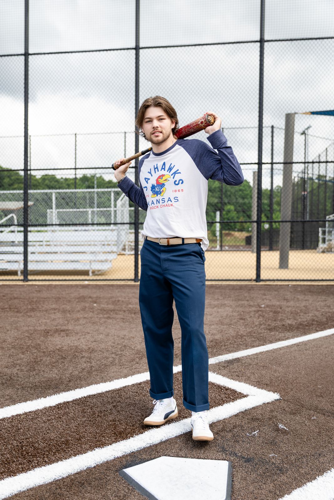 a man holding a baseball bat on a baseball field
