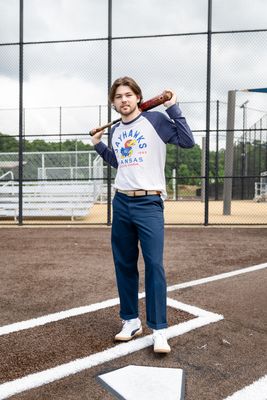 a man holding a baseball bat on a baseball field