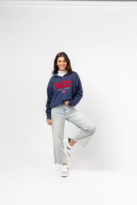 a woman posing for a picture wearing a sweatshirt and sweatpants