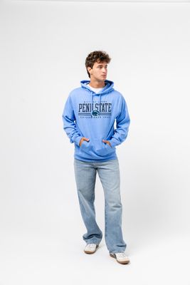 a man in a blue hoodie is standing with his hands in his pockets