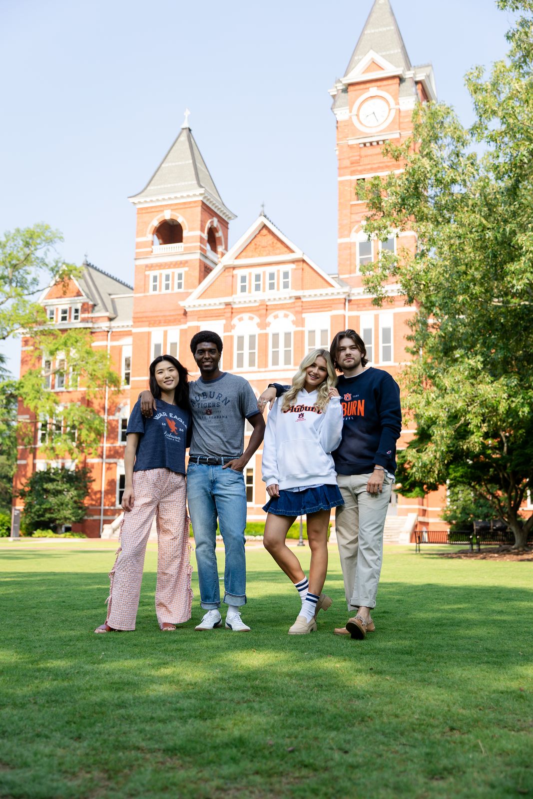 a group of people standing on top of a lush green field