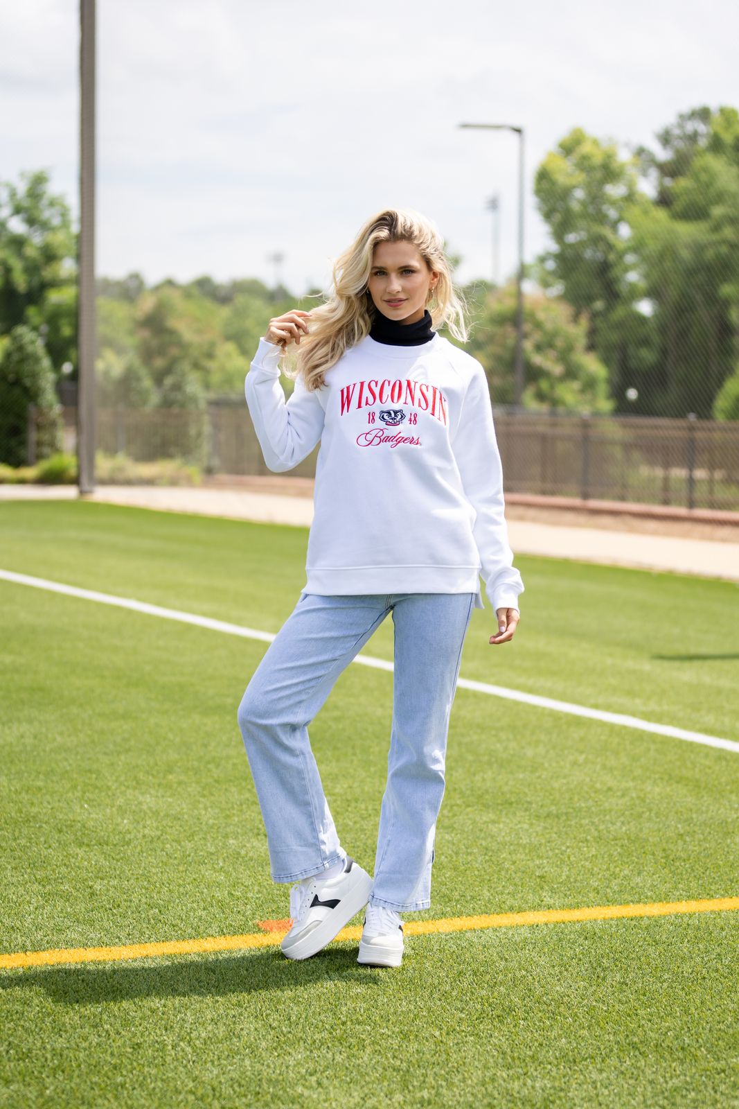 a woman standing on top of a green field
