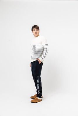 a young man standing in front of a white background