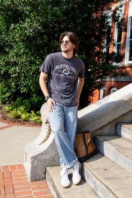 a man sitting on the steps of a building