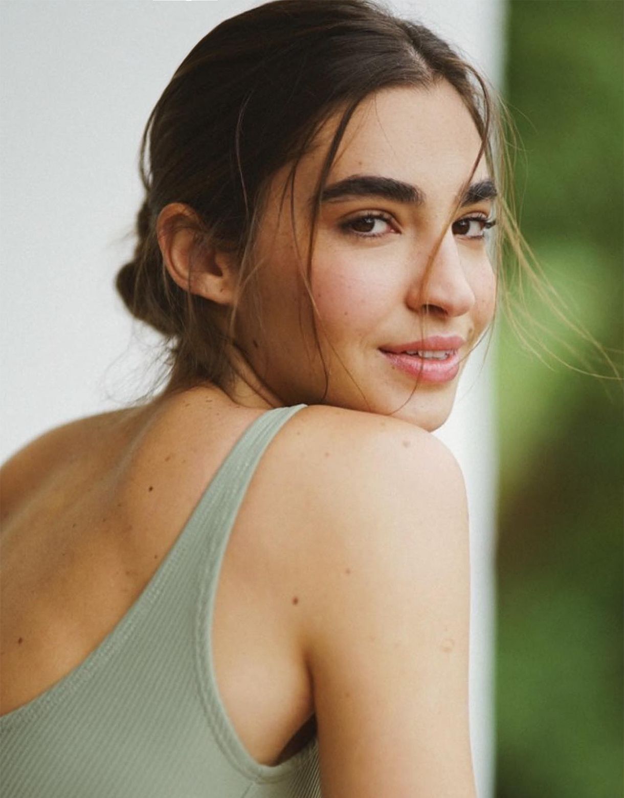 a close up of a person wearing a tank top