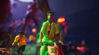 a man riding a bike down a street at night