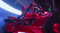 a close up of a red motorcycle with a person on it