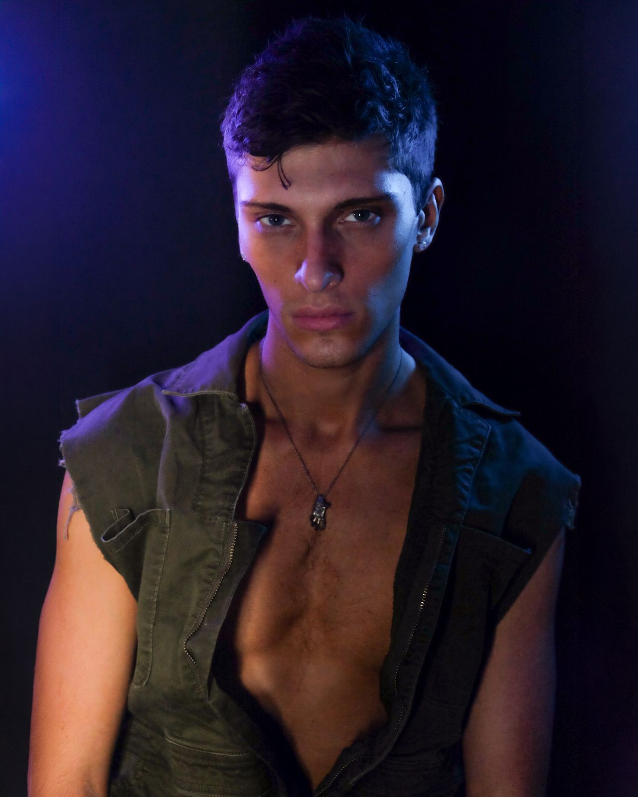 a man with no shirt on posing for a picture