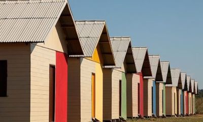 a row of colorful beach huts sitting next to each other