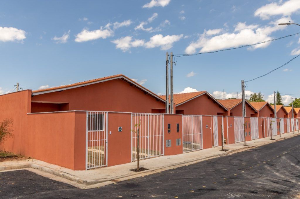 a row of orange buildings next to a street