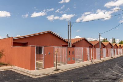 a row of orange buildings next to a street