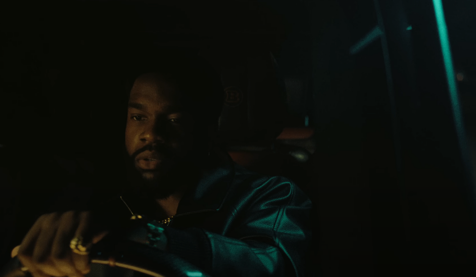 a man sitting in a car in the dark