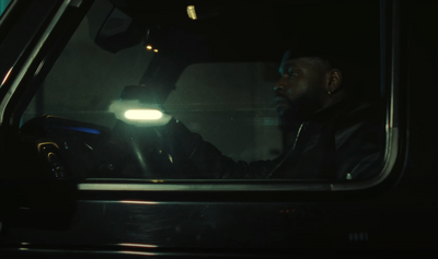 a man driving a car at night in the dark