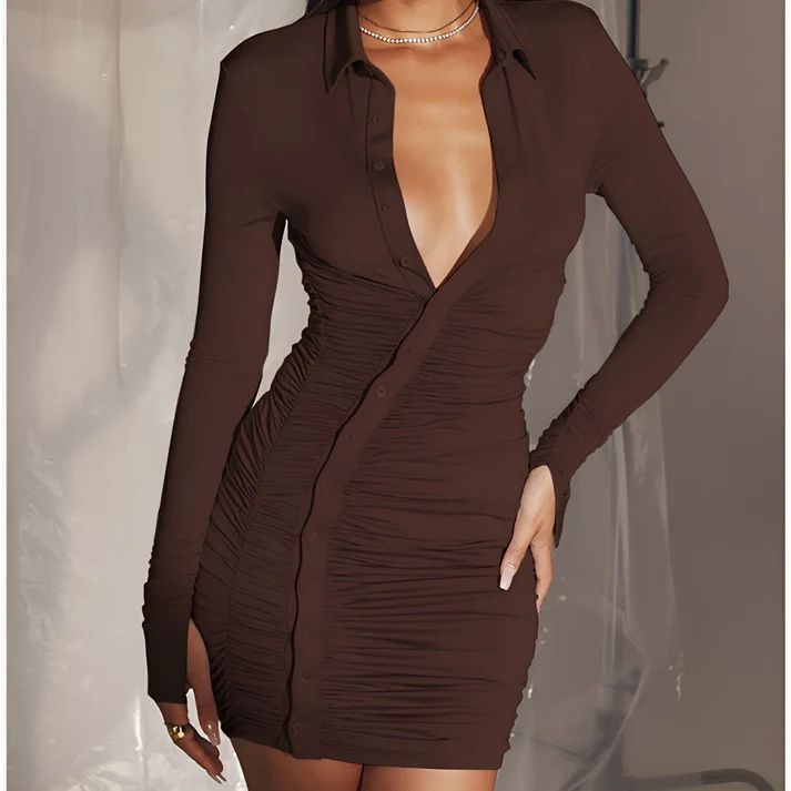 a woman in a brown dress posing for a picture