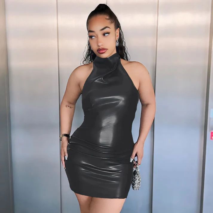 a woman in a black dress posing for a picture