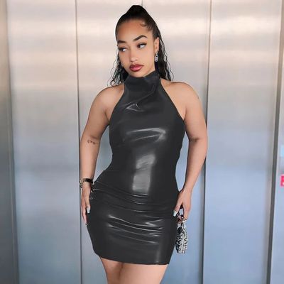 a woman in a black dress posing for a picture