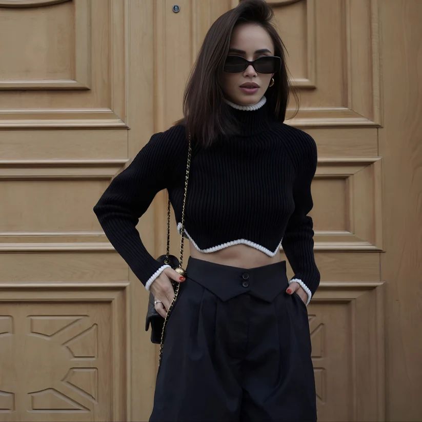 a woman wearing a black top and black pants
