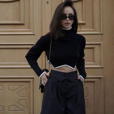 a woman wearing a black top and black pants