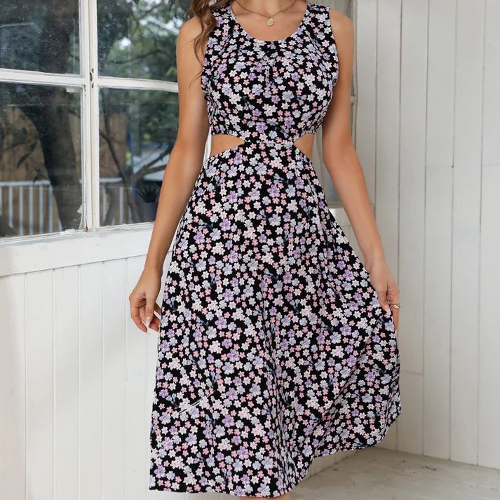 a woman wearing a black and white floral dress