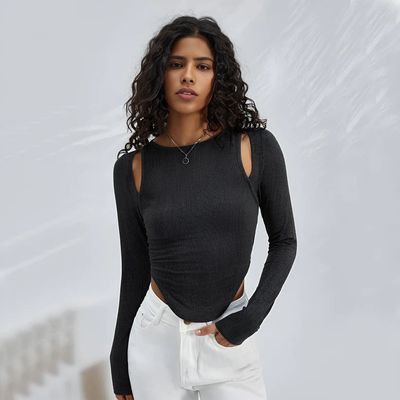 a woman wearing a black top and white pants