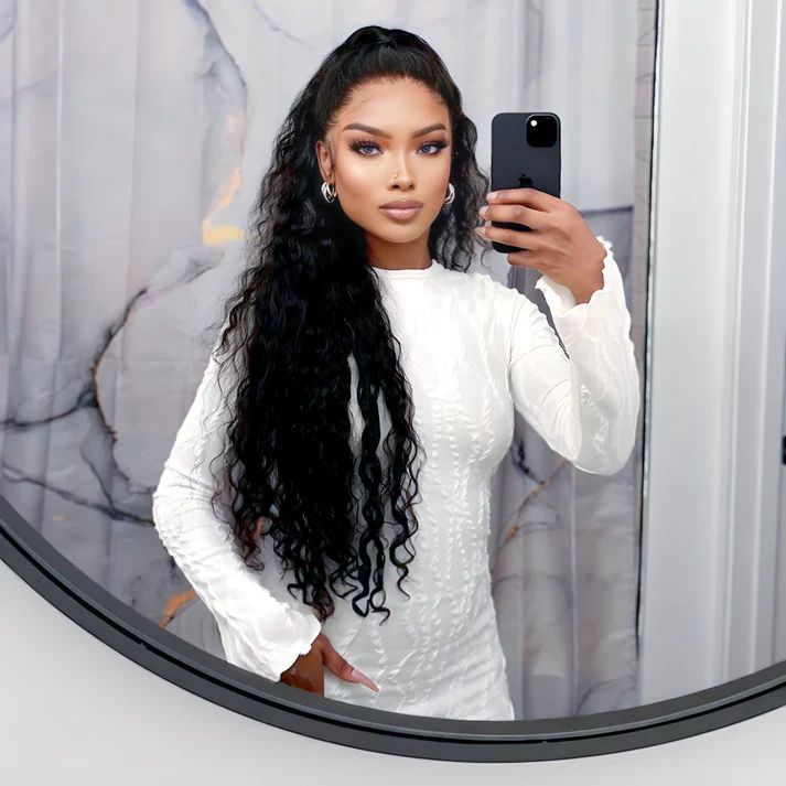 a woman taking a selfie in front of a mirror