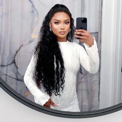 a woman taking a selfie in front of a mirror