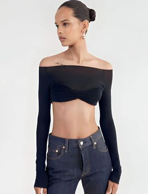 a woman wearing a black top and jeans