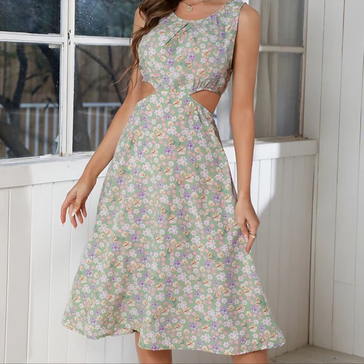a woman wearing a dress with a cut out back
