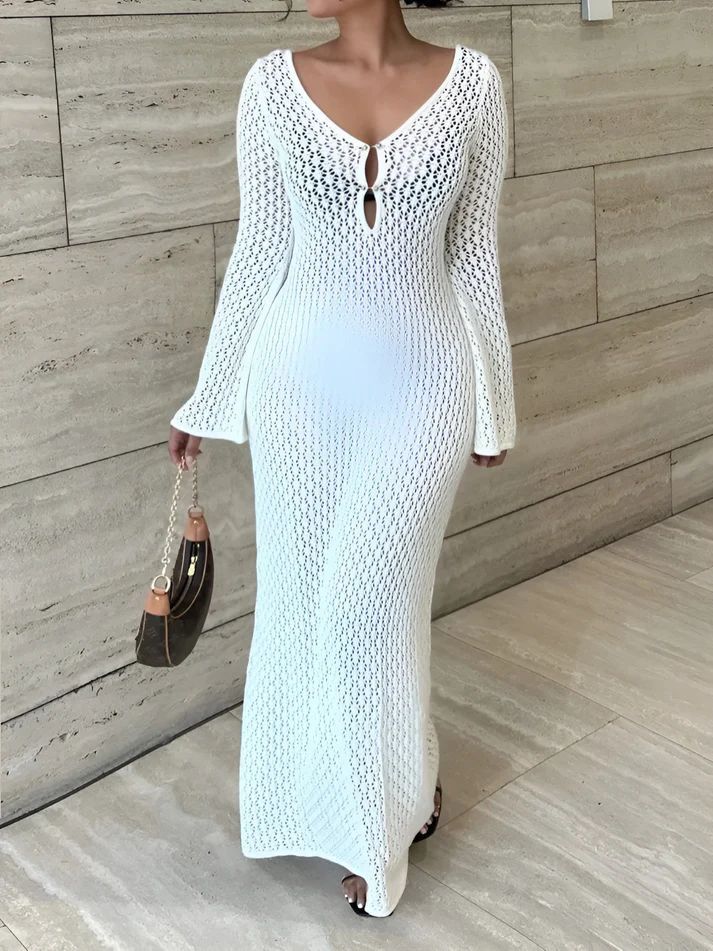 a woman wearing a white knitted dress