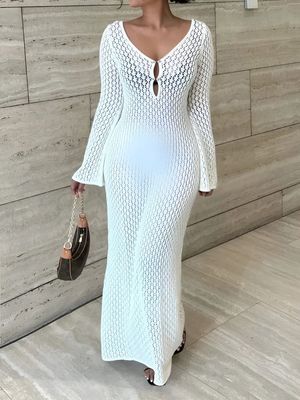 a woman wearing a white knitted dress