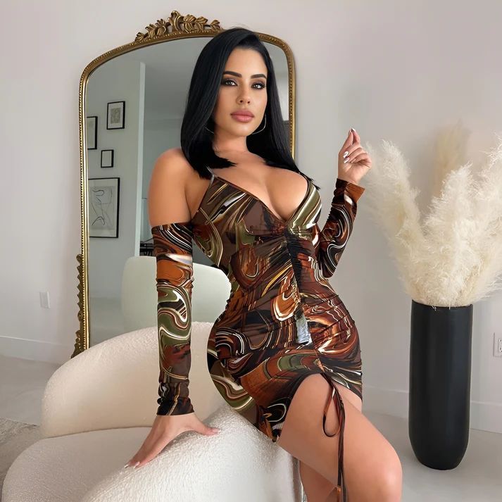 a woman in a dress posing in front of a mirror