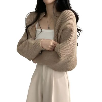 a woman with her arms crossed posing for a picture