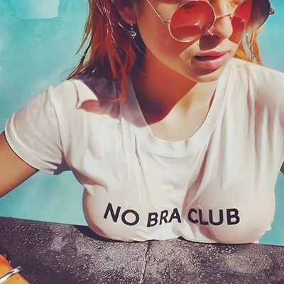 a woman wearing sunglasses and a no bra club shirt