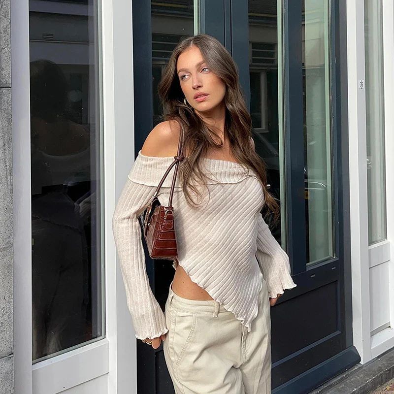 a woman standing in front of a building with her hands on her hips
