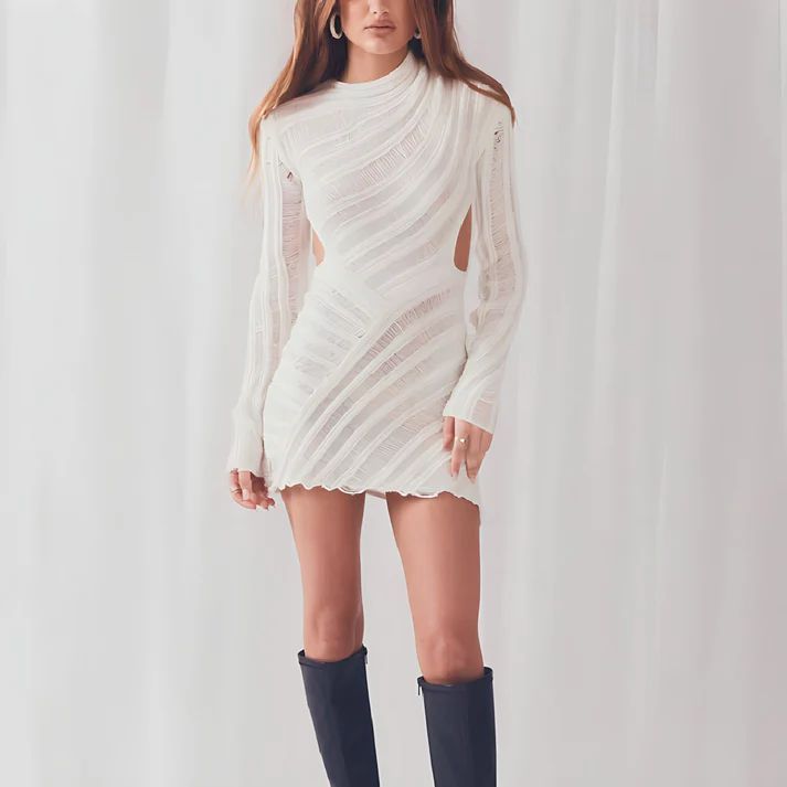 a woman in a white dress and knee high boots
